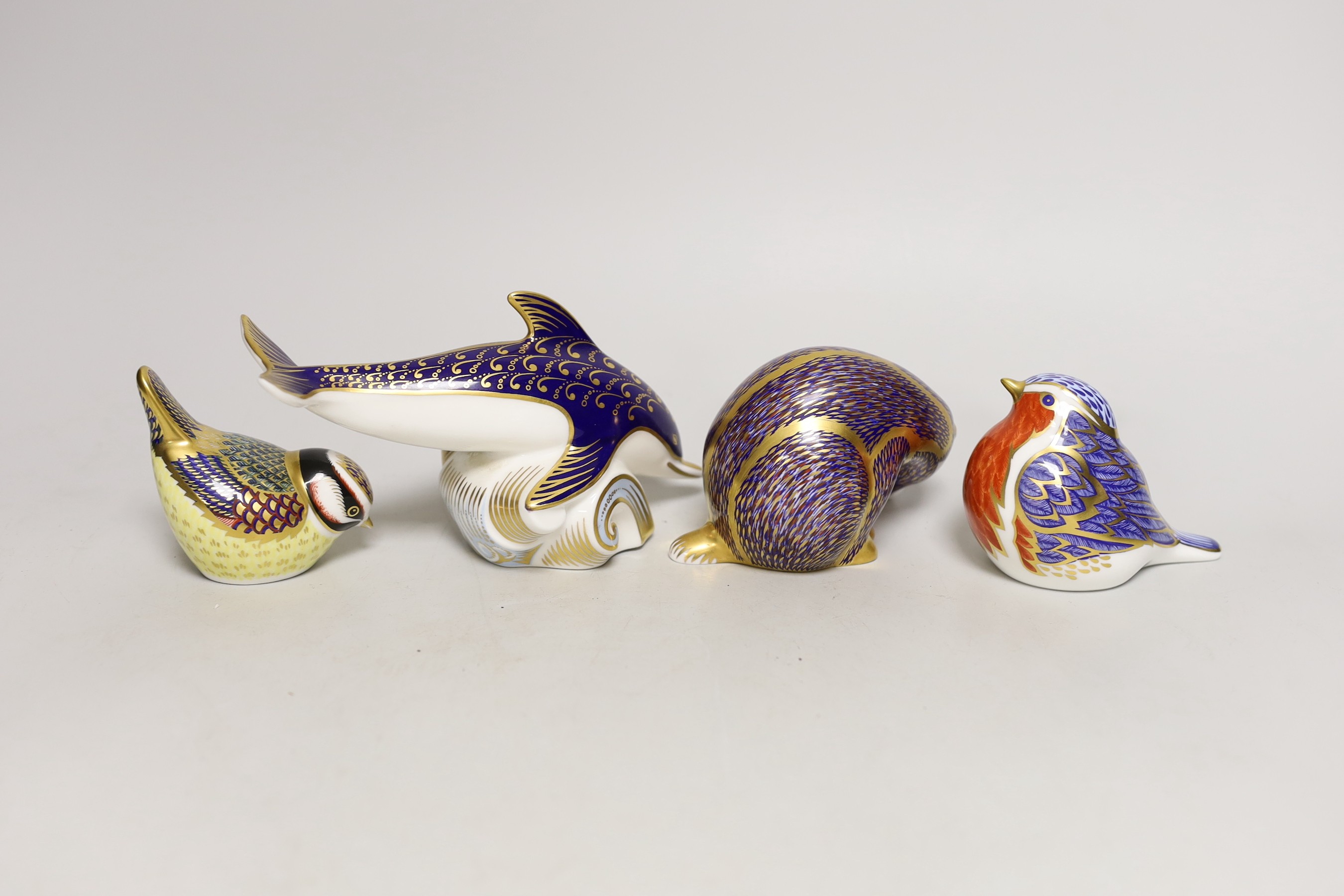 Four Royal Crown Derby paperweights - dolphin, badger and two birds